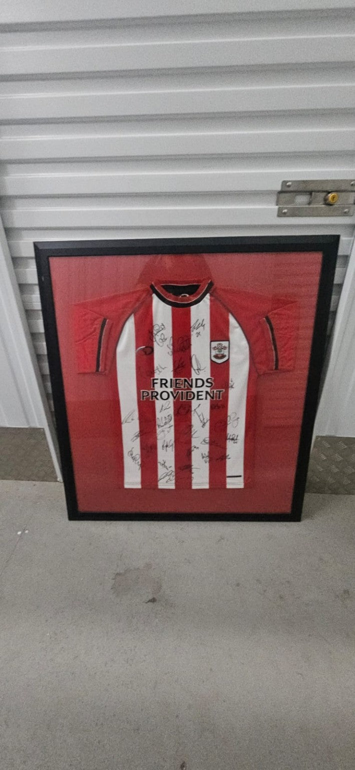 Full view of Southampton FC multi-signed shirt in its original black frame