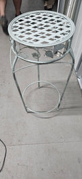 Decorative pale green-grey metal round plant stand with lattice top and leaf detailing