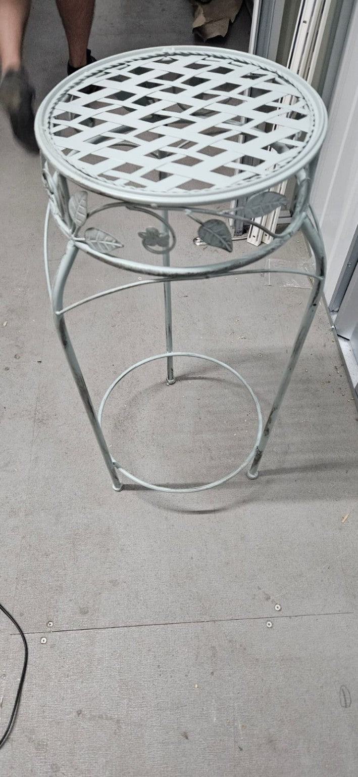 Decorative pale green-grey metal round plant stand with lattice top and leaf detailing