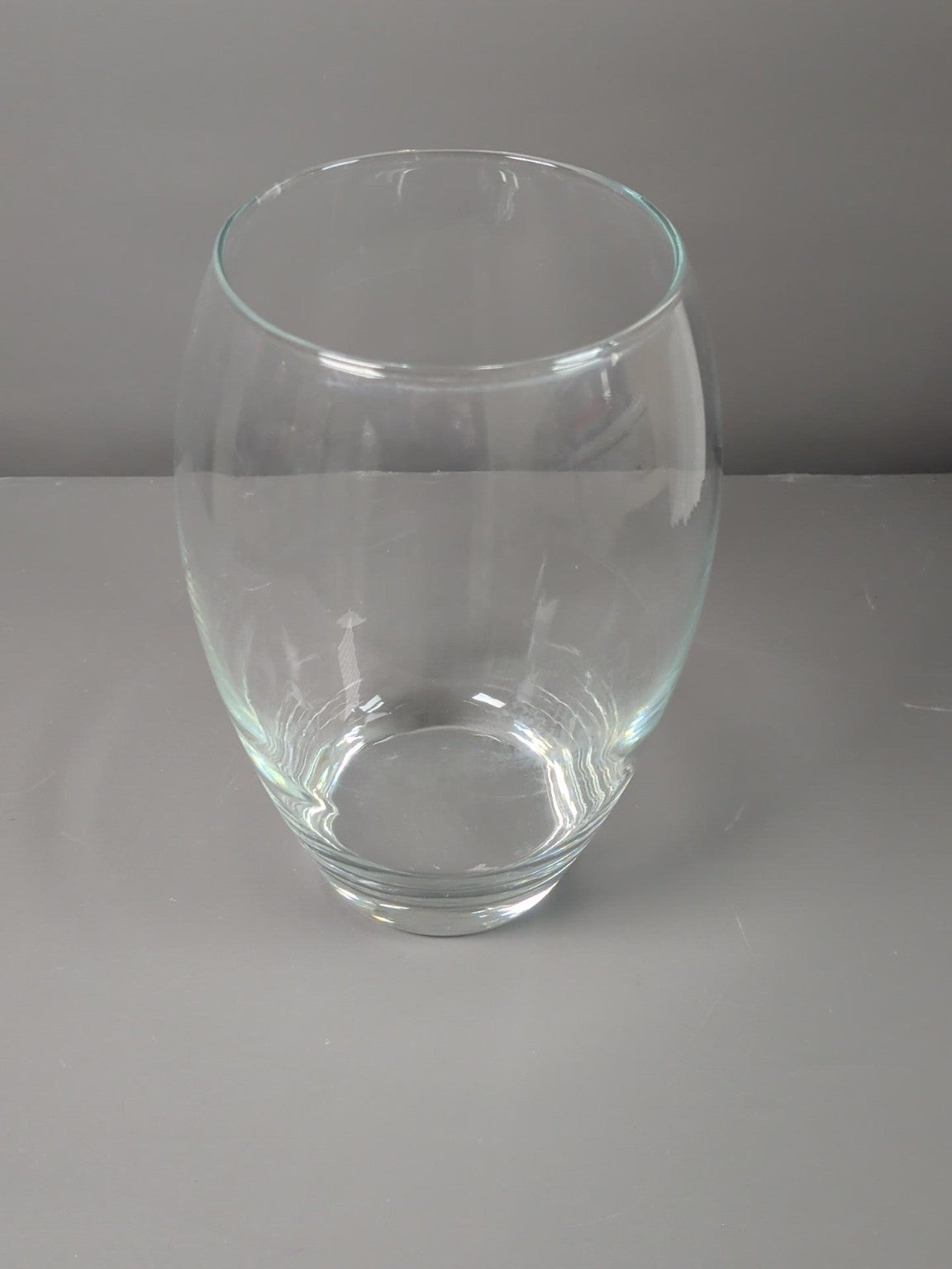 Clear rounded glass vase with heavy base