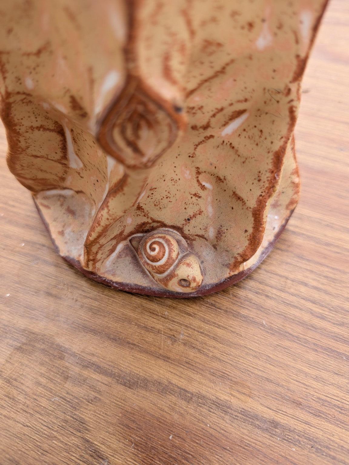 Close-up of snail detail on handmade studio pottery