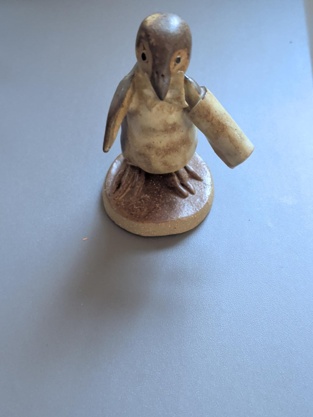 Pottery penguin waiter holding a cloth