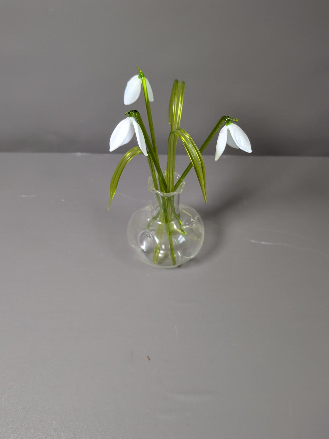Glass snowdrop flower arrangement in vase