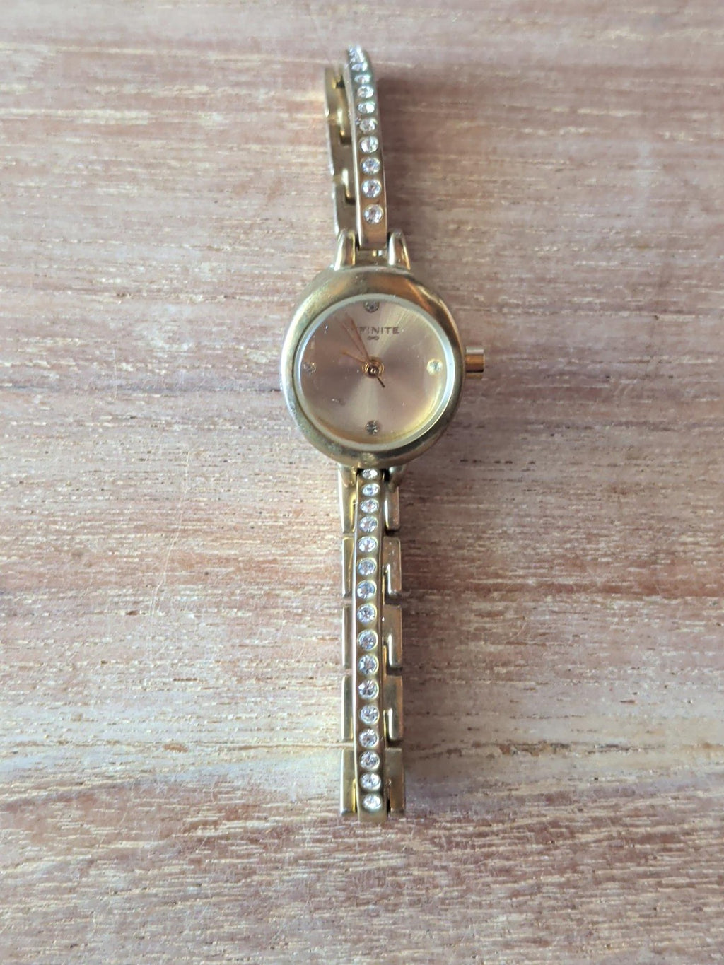 Infinite ladies gold-tone crystal bracelet watch