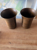 Pair of vintage copper brass beakers with aged patina