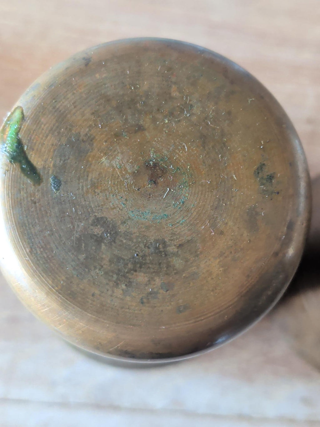 Base of vintage copper brass beaker showing natural patina