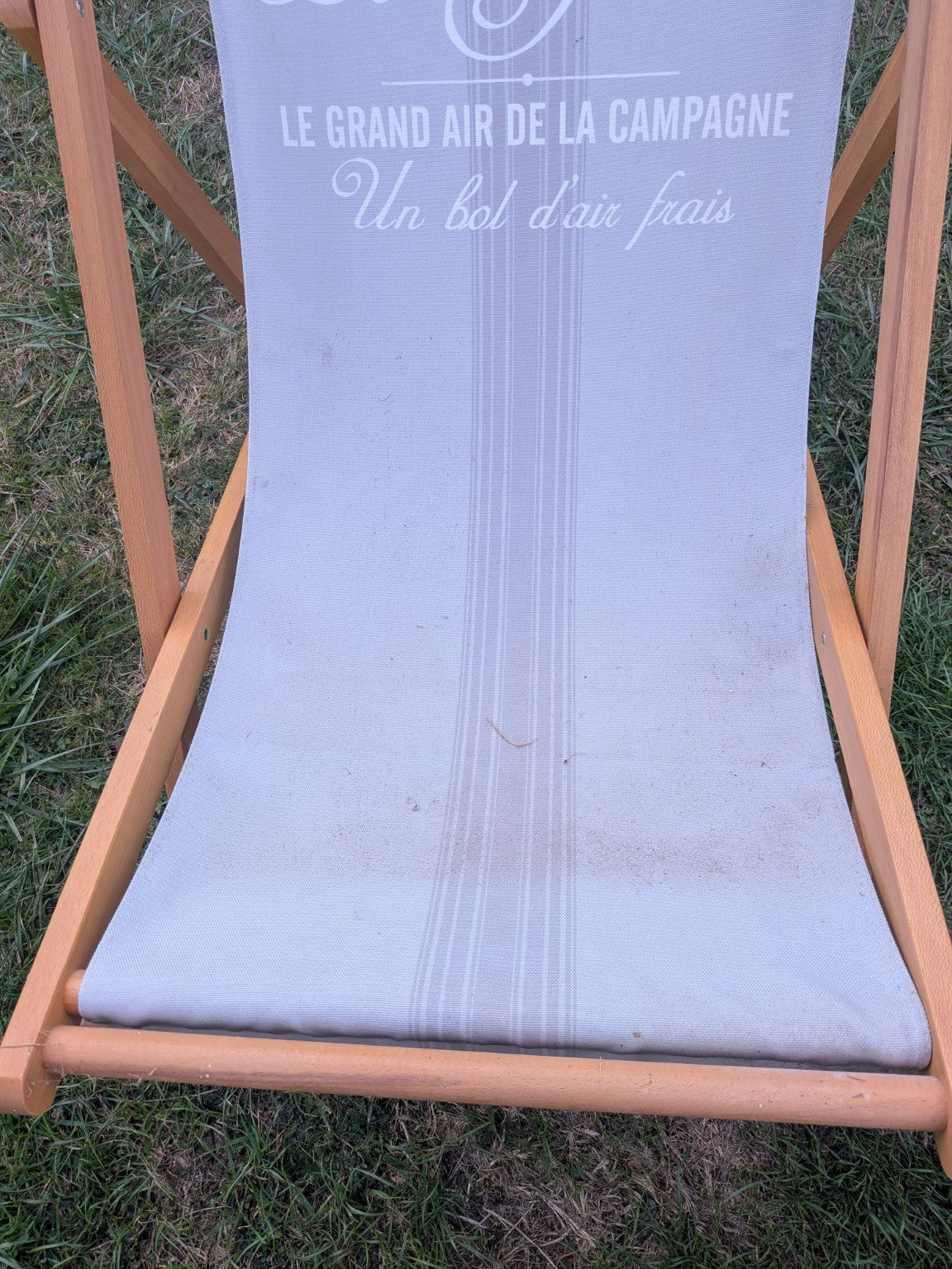 Le Jardin deck chair fabric close-up showing marks and wear