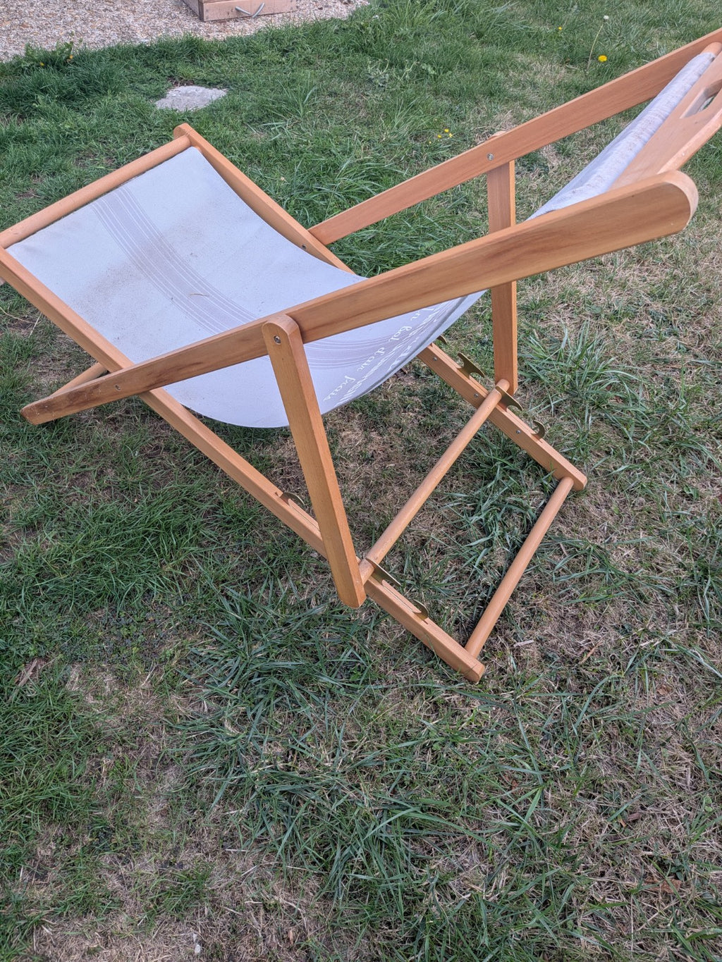 Wooden folding deck chair side view showing adjustable frame