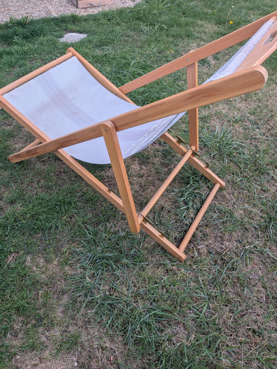 Wooden folding deck chair side view showing adjustable frame
