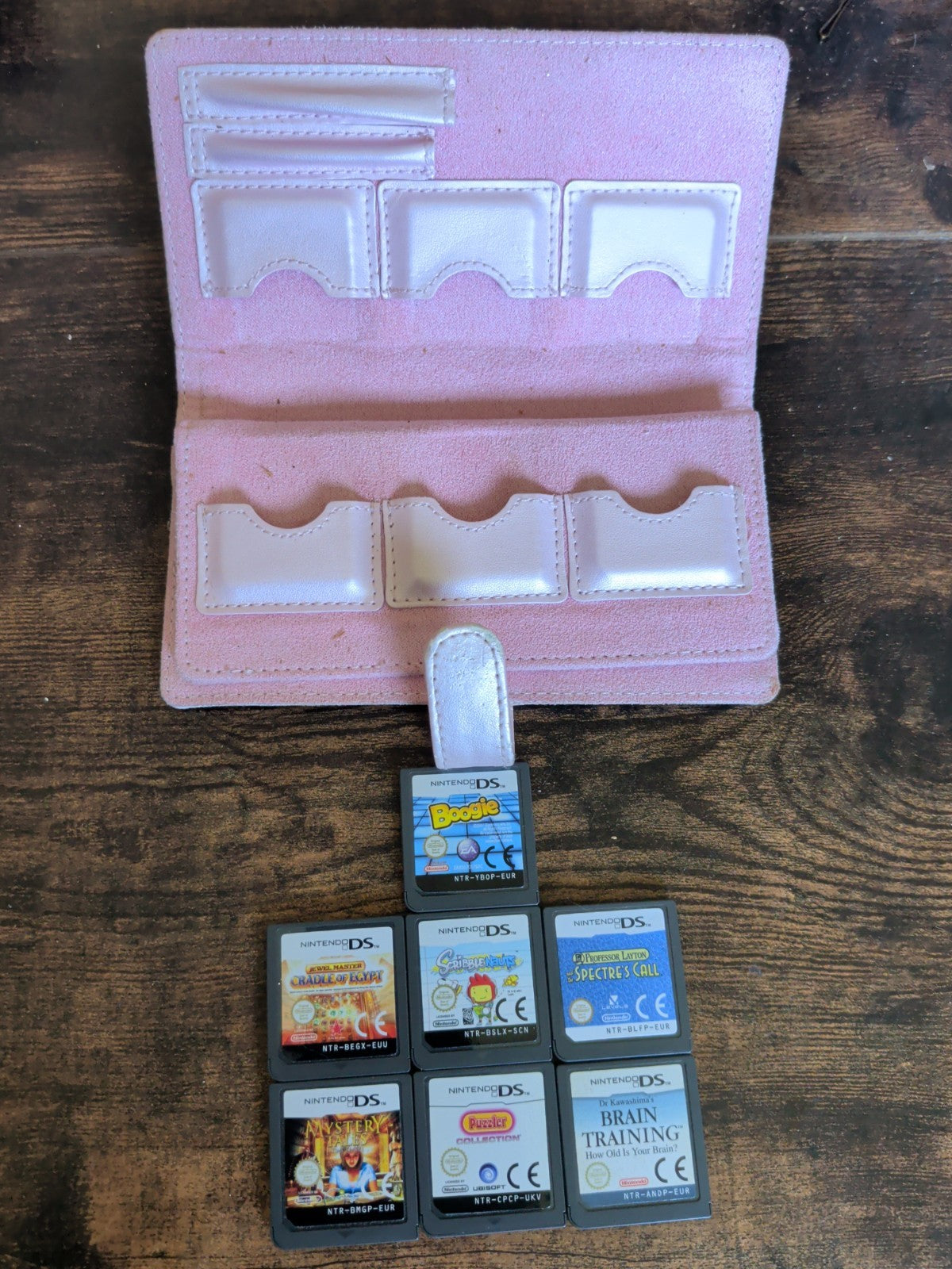 Nintendo DS seven game cartridges with pink storage case