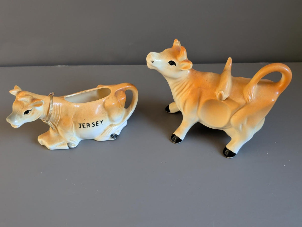 Pair of vintage-style ceramic cow creamers in matching tan and cream glaze