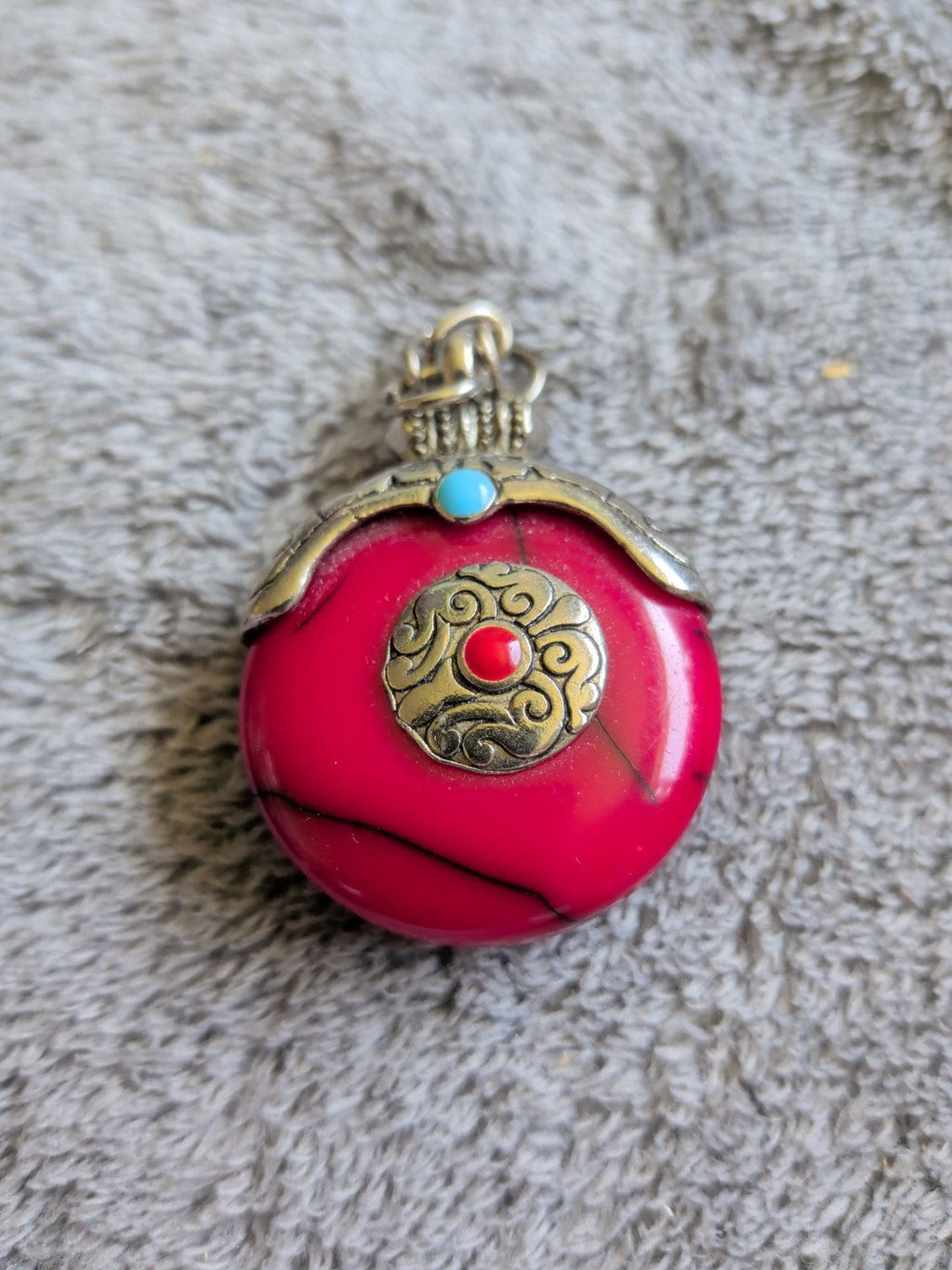 Tibetan style pink stone effect pendant front