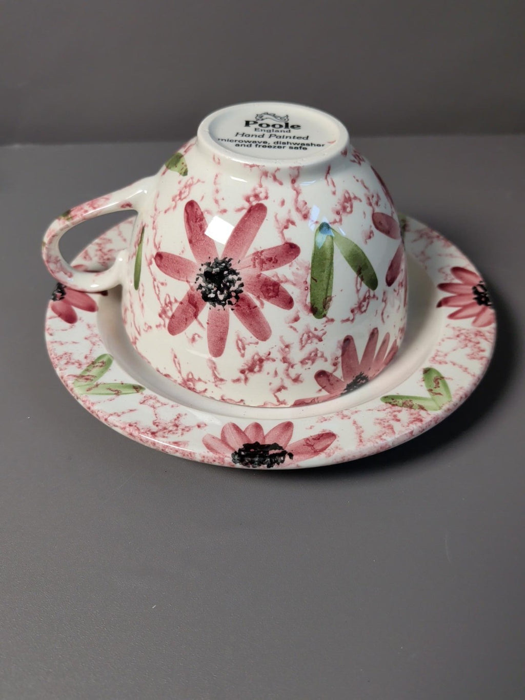 Two matching Poole Pottery floral cup and saucer sets