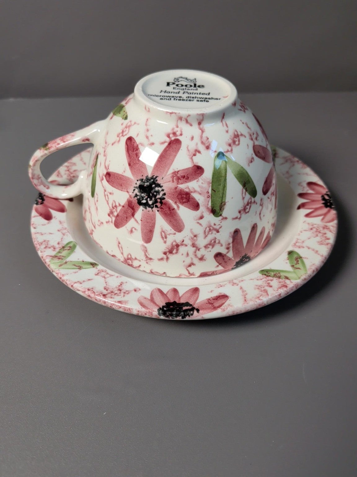 Two matching Poole Pottery floral cup and saucer sets