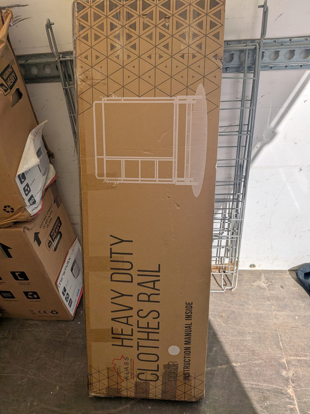 Actual factory-sealed box of the Klass Home Collection white clothes rail