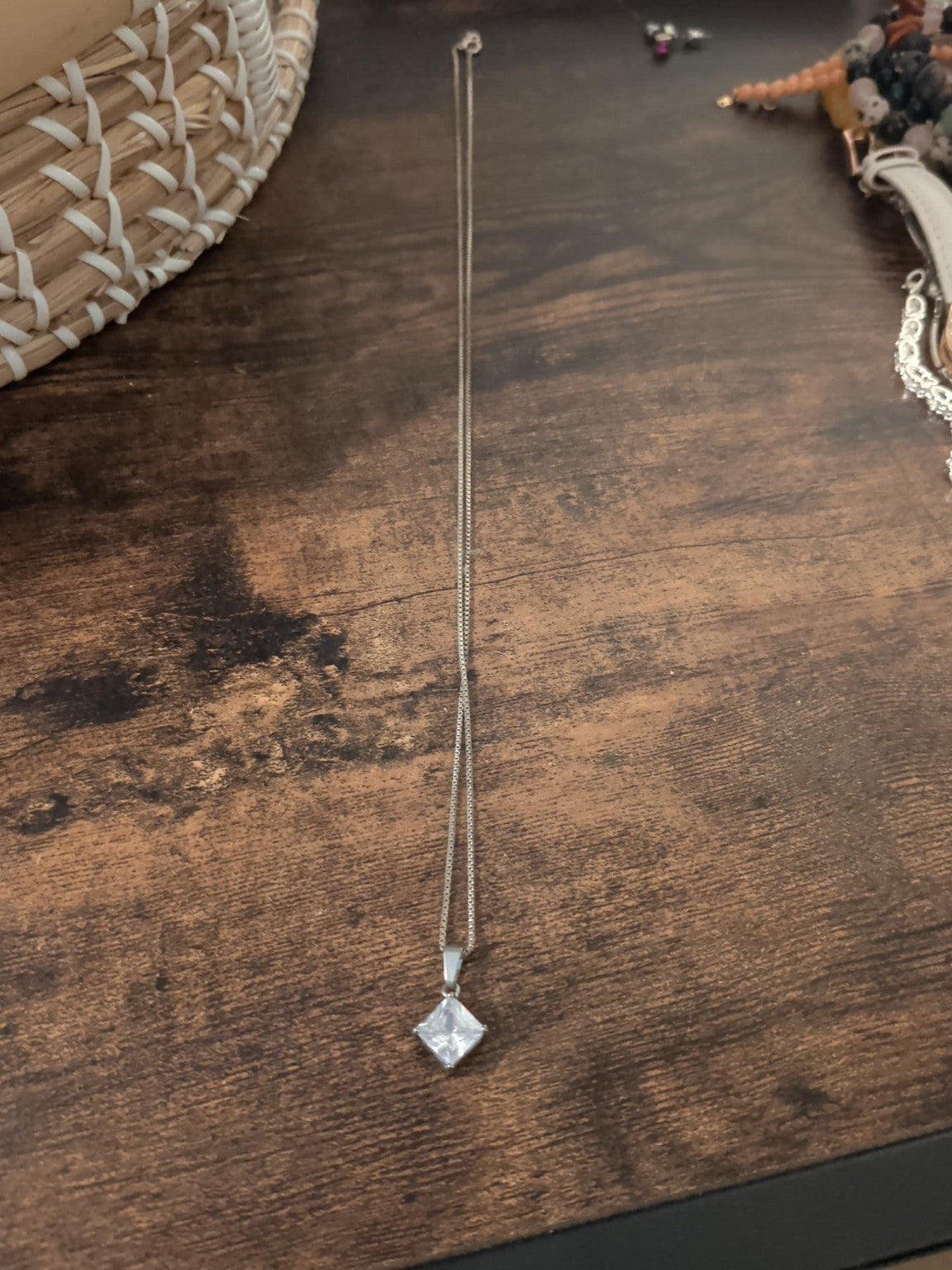 Silver-coloured necklace with clear square-cut pendant