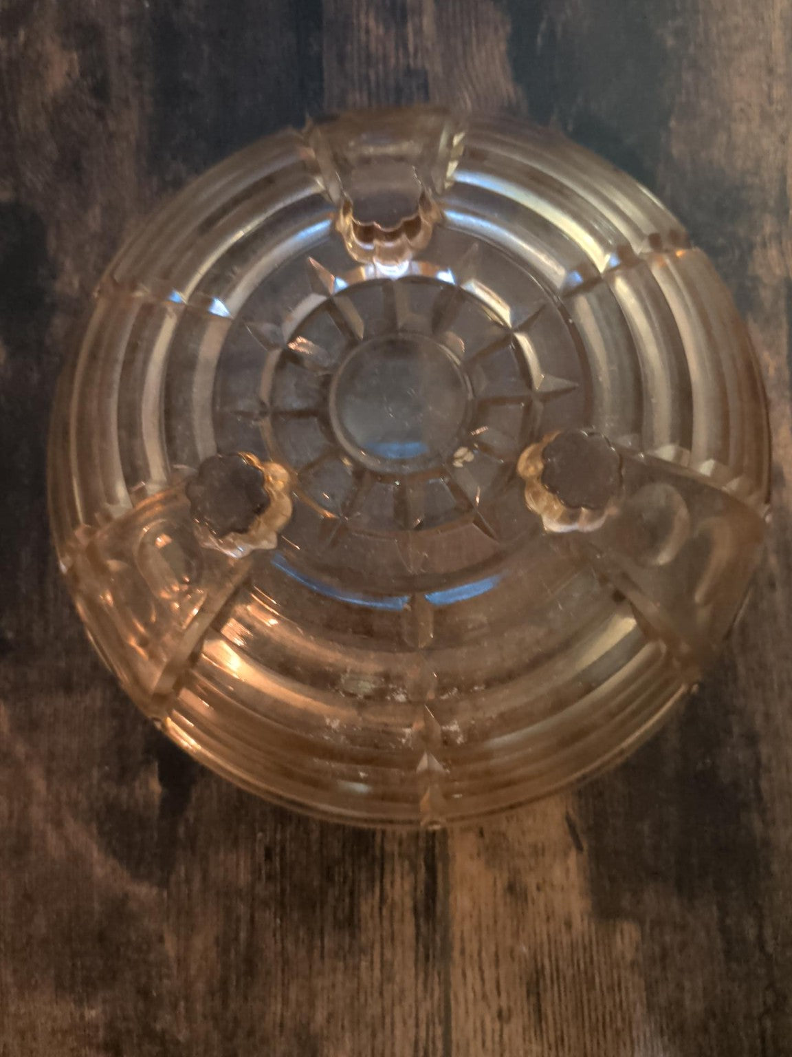 Three-footed base of amber glass bowl