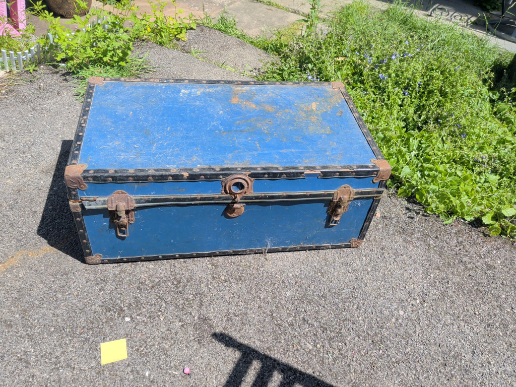 Vintage blue metal-bound travel trunk with aged iron fittings