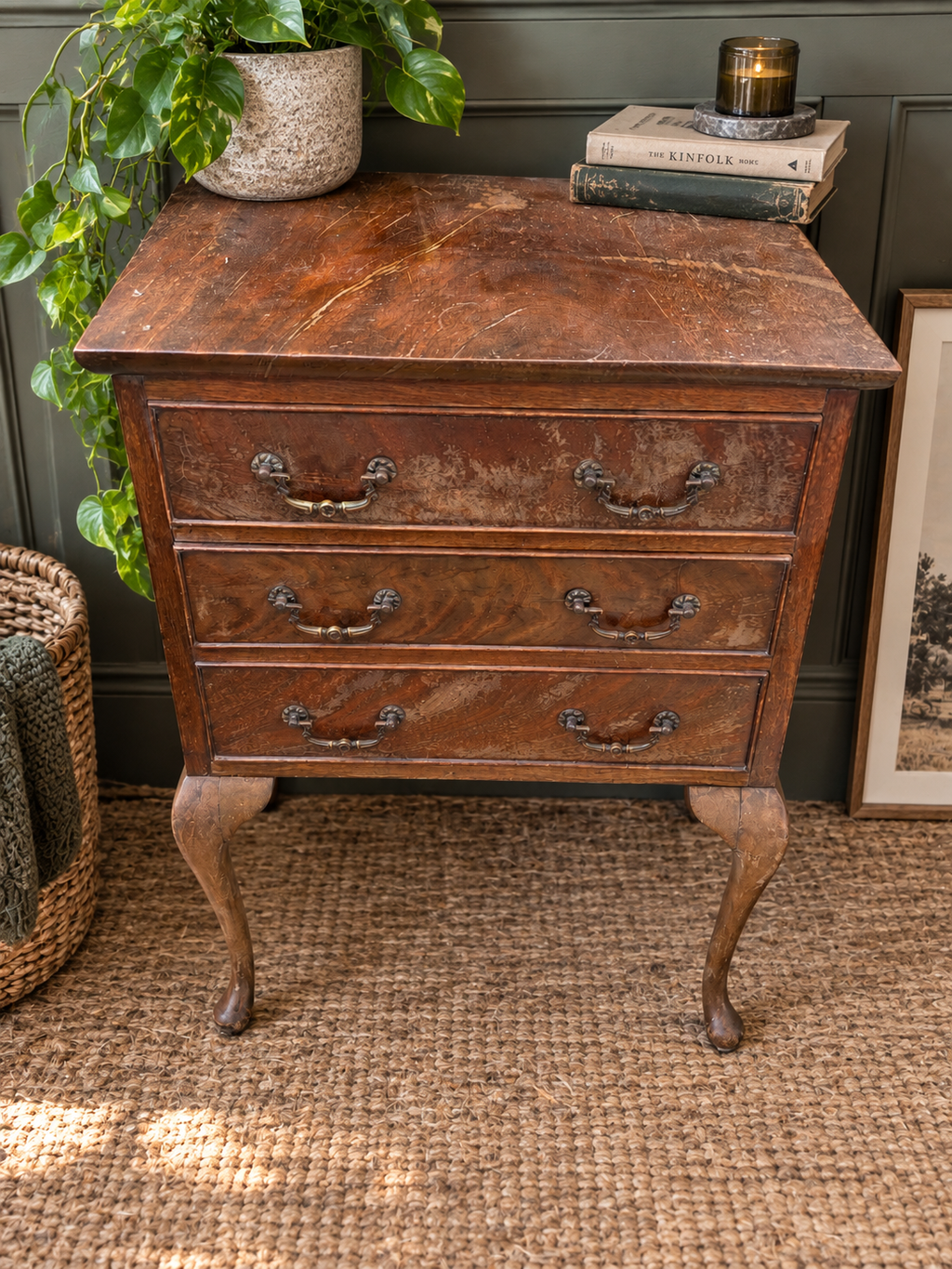Vintage three drawer wooden chest with cabriole legs styled in a modern vintage interior