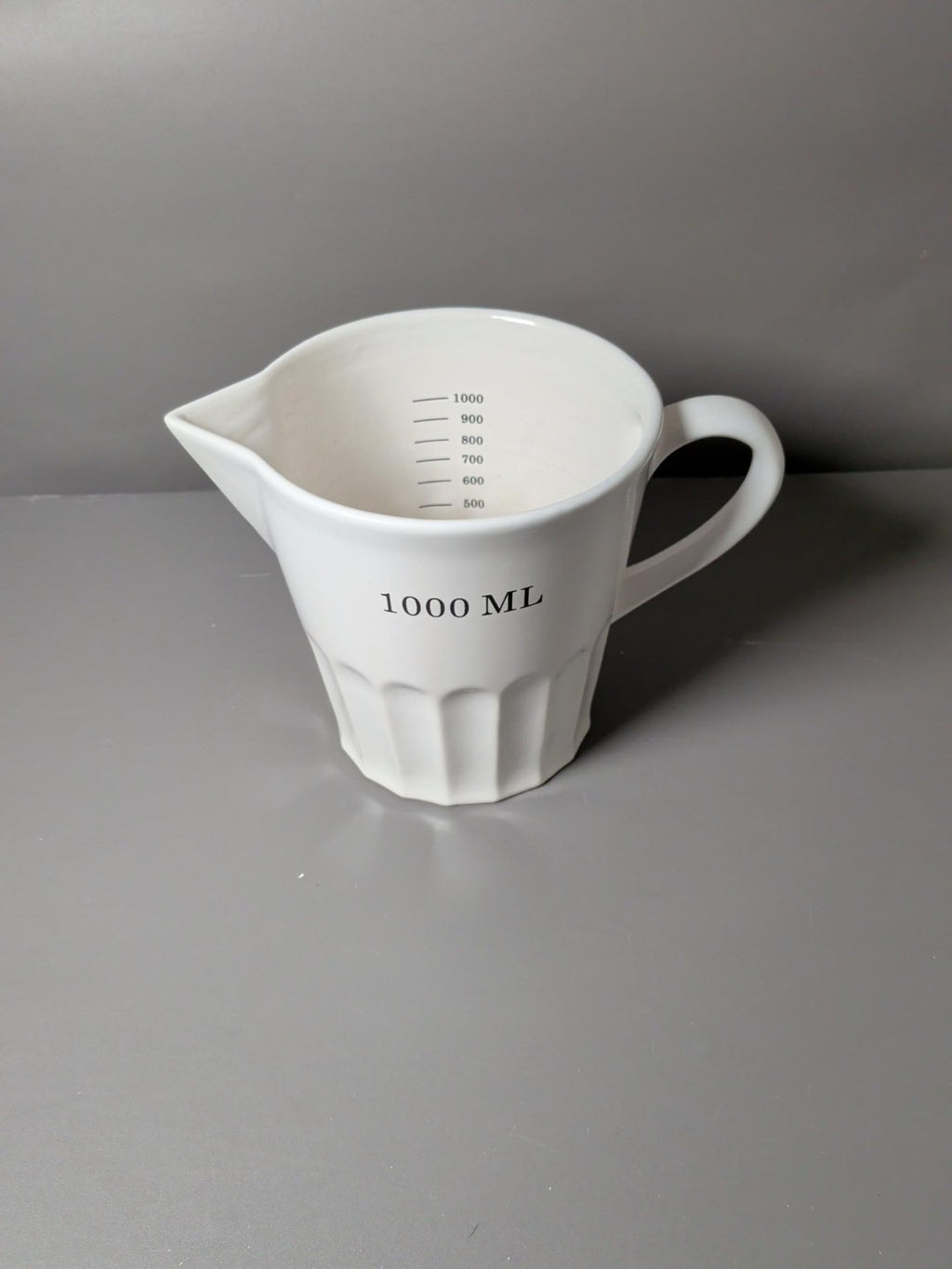 White ceramic 1 litre measuring jug with handle and pouring spout
